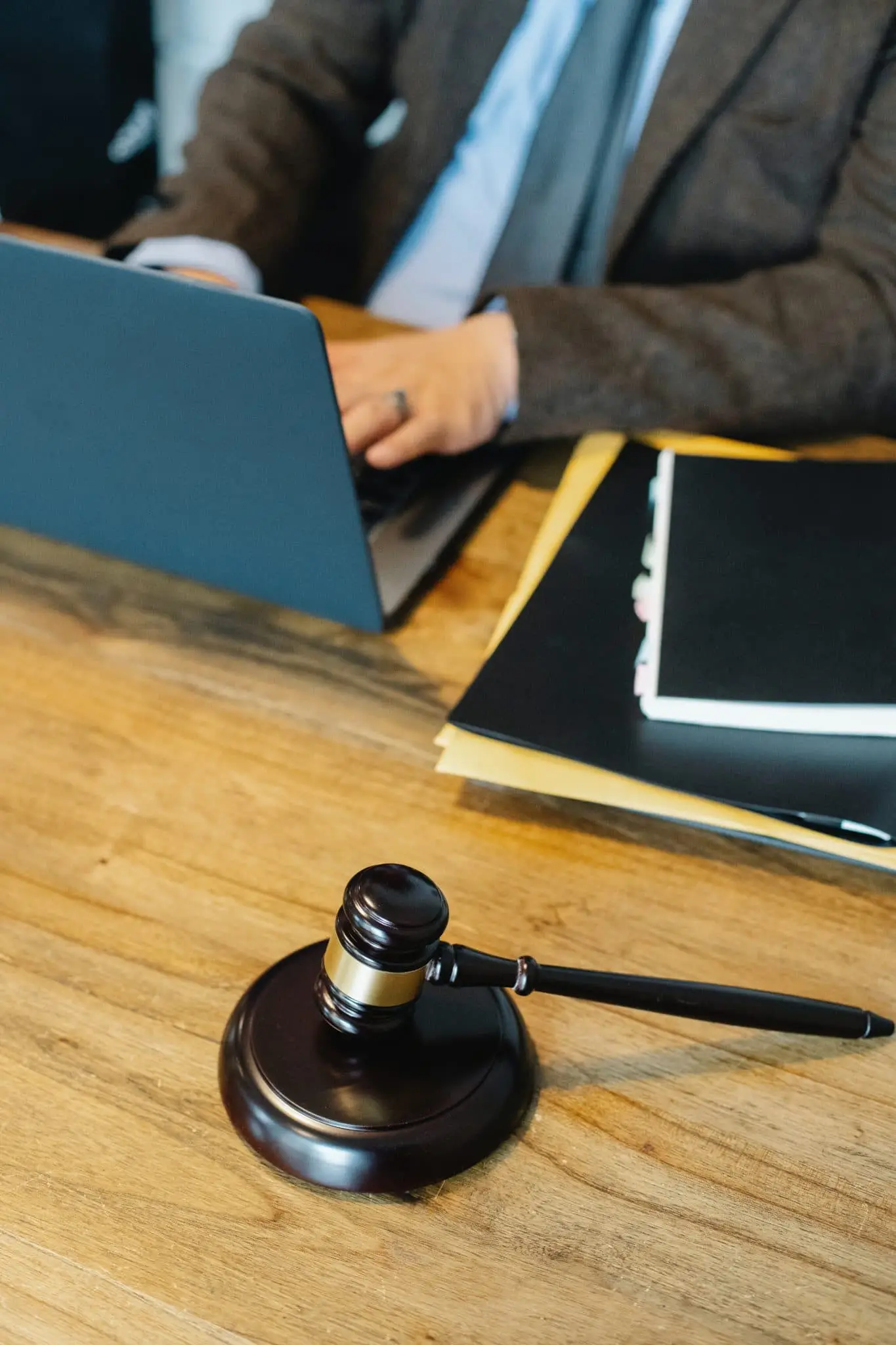 Gavel and Man working on Laptop— Unfair Dismissal Solutions in Australia